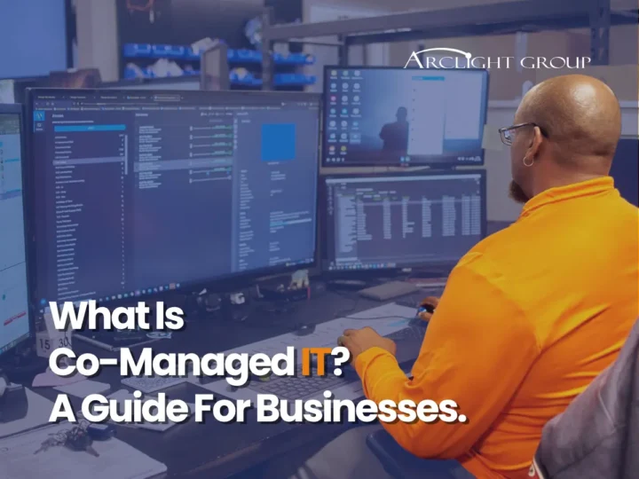 ArcLight Group technician working across multiple monitors, titled What Is Co-Managed IT? A Guide For Businesses