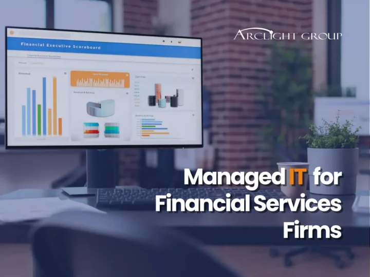 Financial executive dashboard on a monitor with the title Managed IT for Financial Services Firms by ArcLight Group